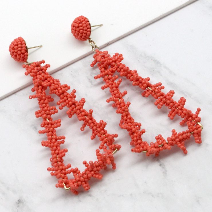 A photo of the Bermuda Triangle Earrings in Coral product