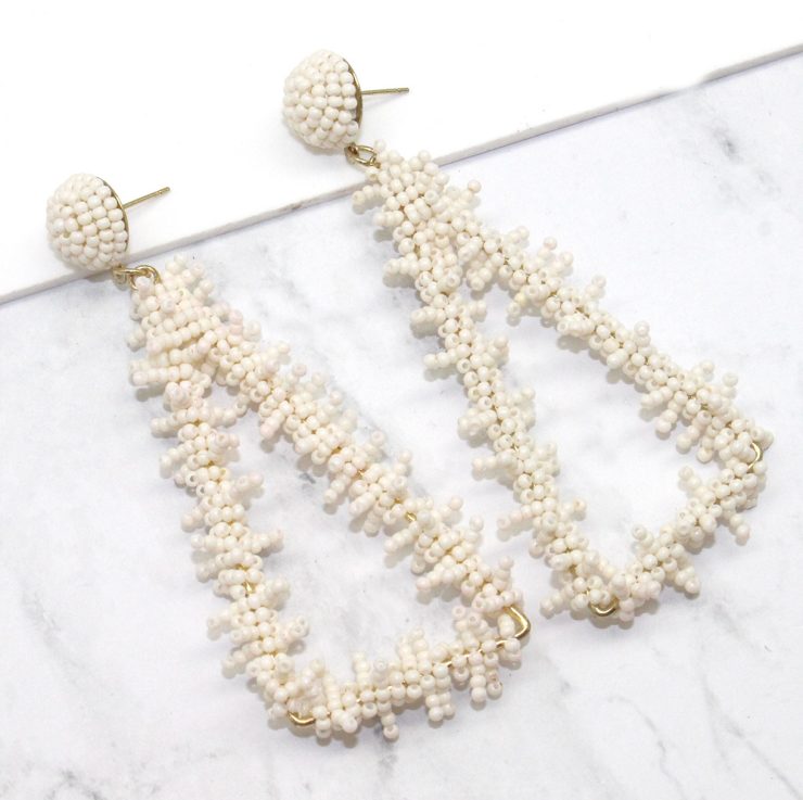 A photo of the Bermuda Triangle Earrings in White product