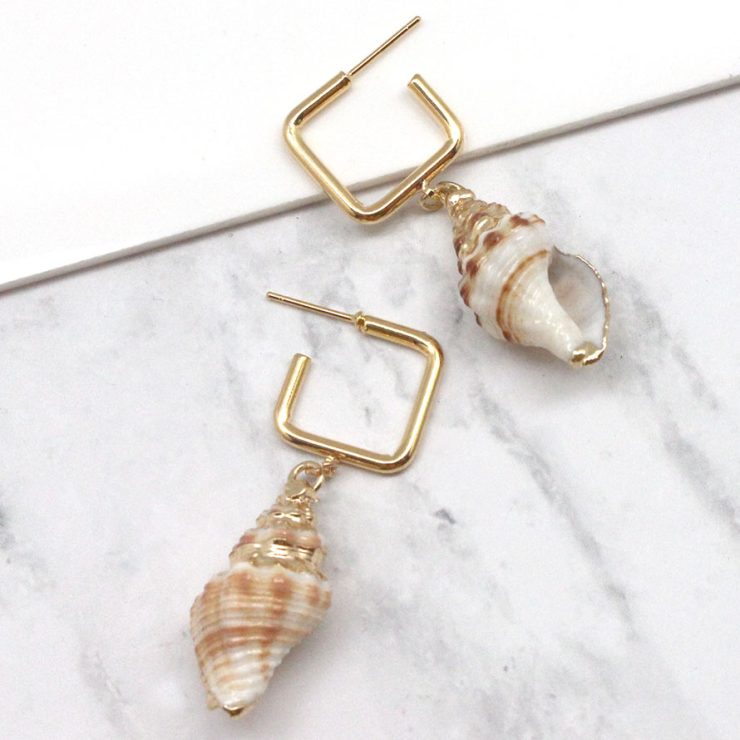 A photo of the Shell Hoop Earrings product