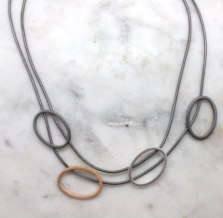 A photo of the Double Tri Tone Necklace product