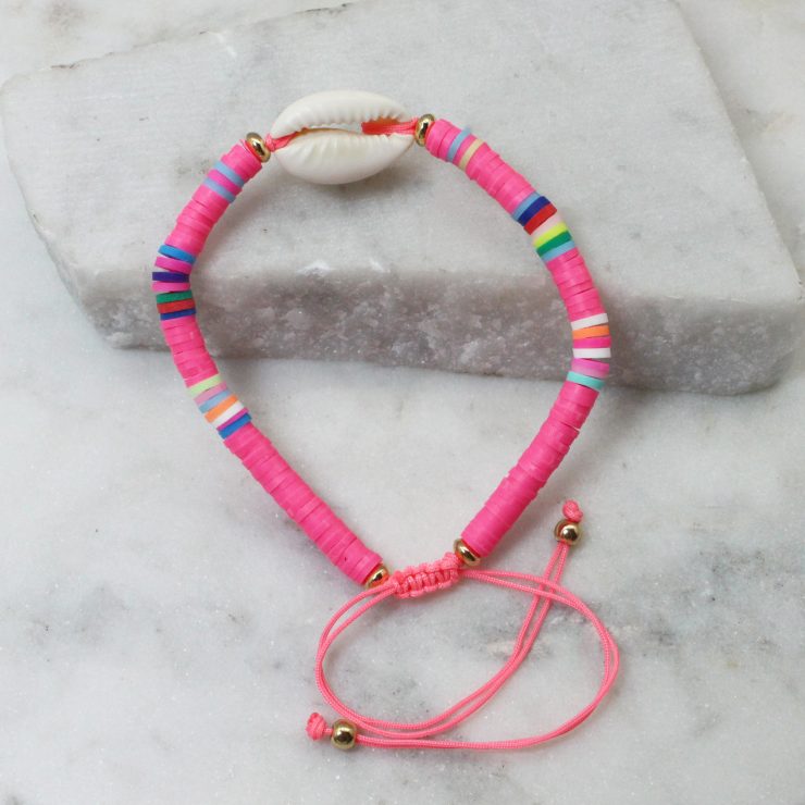 A photo of the Cowrie Shell Adjustable Bracelet In Pink product