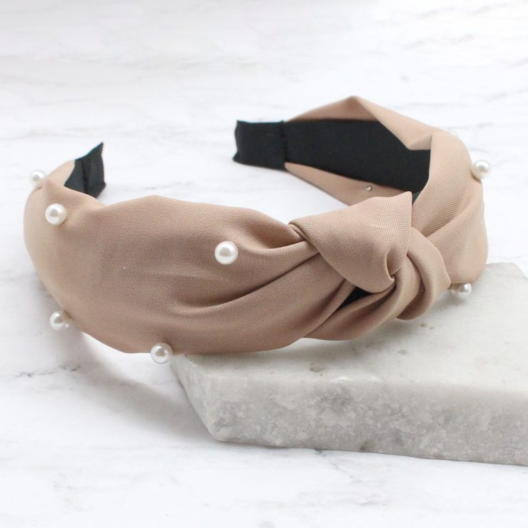 A photo of the Pearl Knot Headband in Nude product