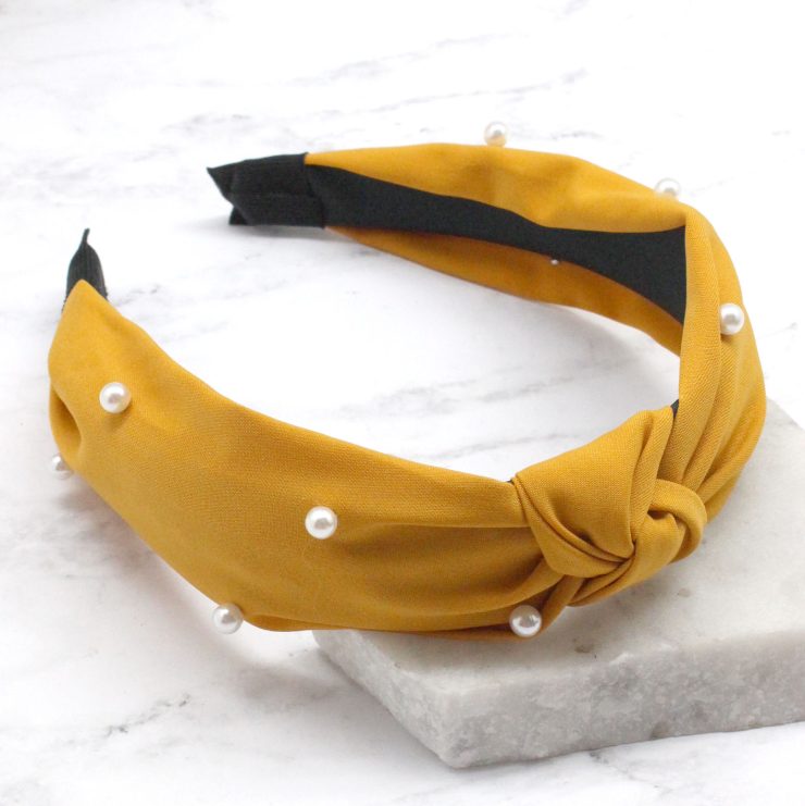 A photo of the Pearl Knot Headband in Nude product
