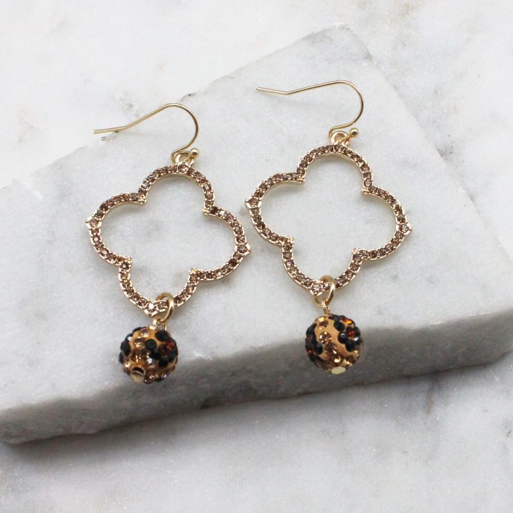 A photo of the Rhinestone Clover Earrings In Leopard product