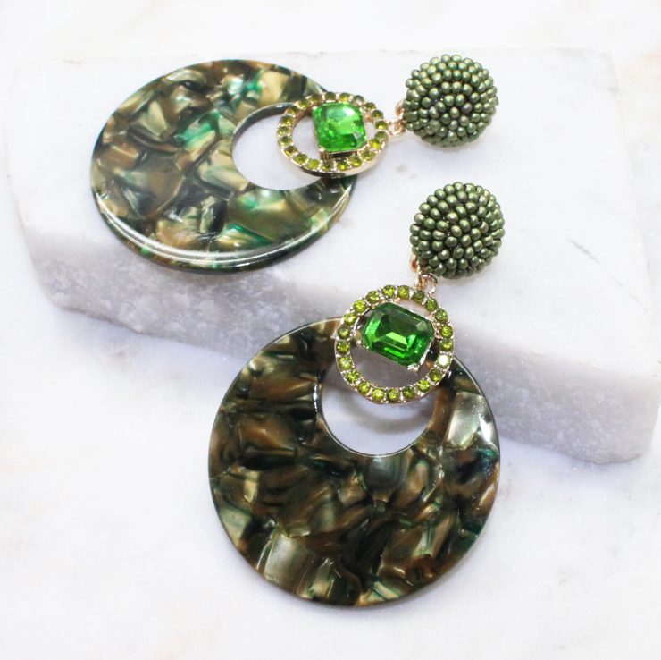 A photo of the Saskia Earrings In Olive product