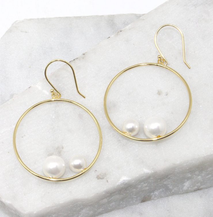 A photo of the Double Pearl Hoop Earrings product