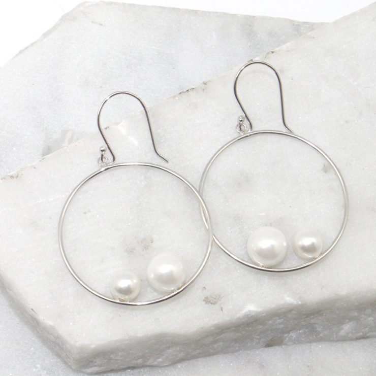 A photo of the Double Pearl Hoop Earrings product