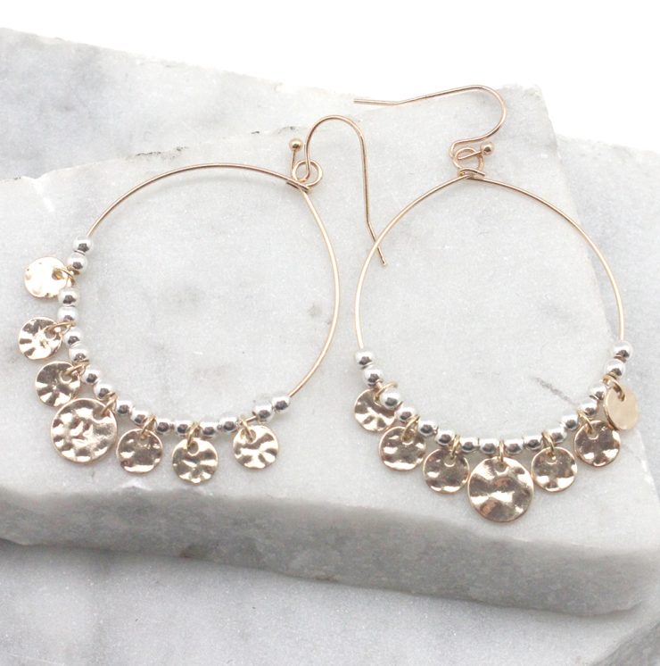 A photo of the Jingle Hoop Earrings in Two Tone product