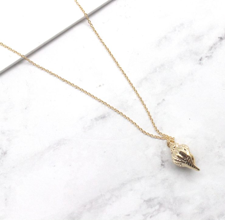 A photo of the Shell We Stay Necklace product