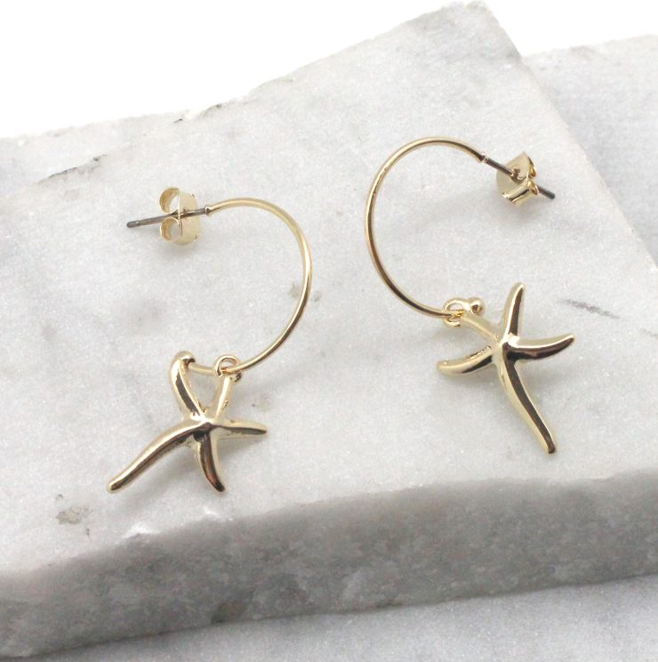A photo of the Starfish Hoop Earrings in Silver product
