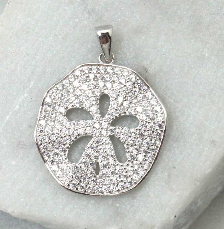 A photo of the Wavy Sand Dollar Pendant product