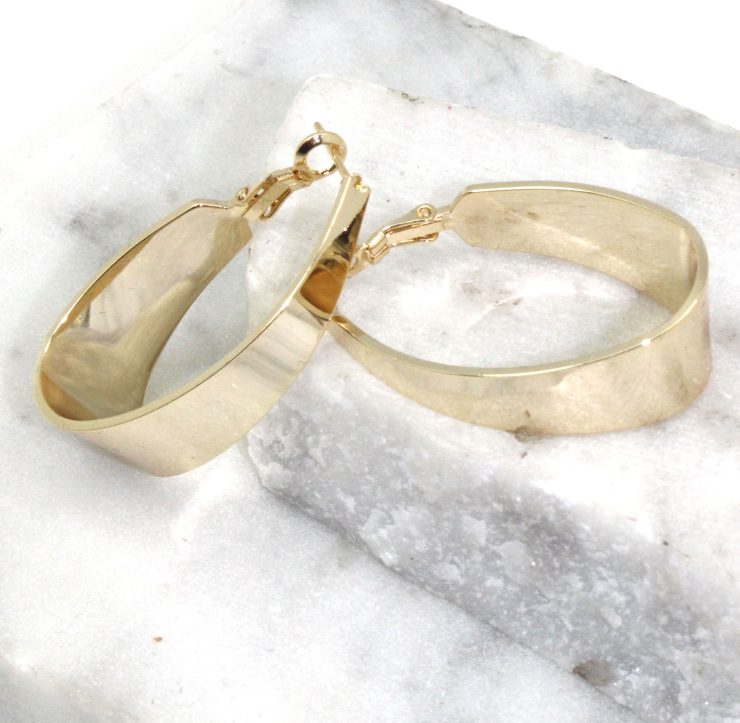 A photo of the Band Hoop Earrings product
