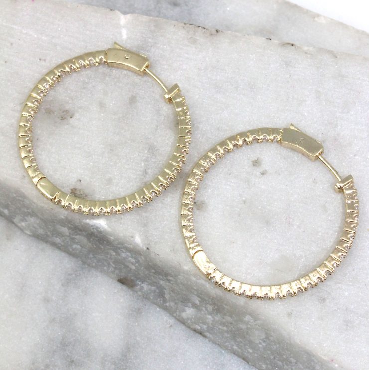 A photo of the Glammed Hoop Earrings product