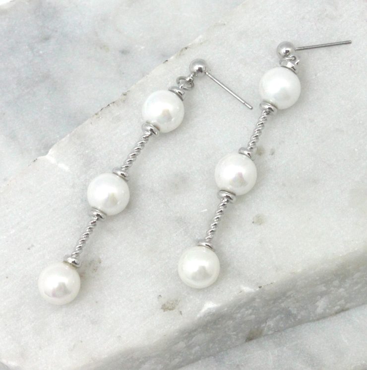 A photo of the Pearl Bar Drop Earrings product
