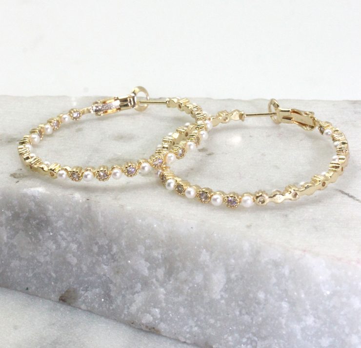 A photo of the Pearl Hoop Earrings product