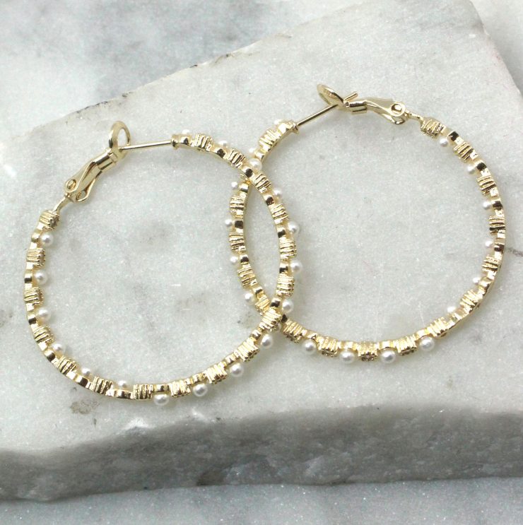 A photo of the Pearl Hoop Earrings product