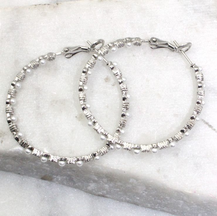 A photo of the Pearl Hoop Earrings product