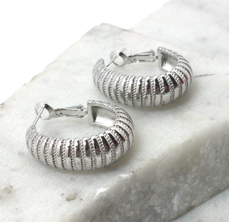 A photo of the Thick Textured Hoop Earrings product
