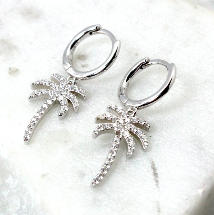 A photo of the Palma Huggie Hoop Earrings product