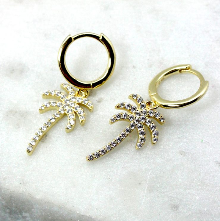 A photo of the Palma Huggie Hoop Earrings product