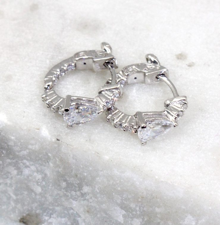 A photo of the Pear Rhinestone Huggie Hoop Earrings product