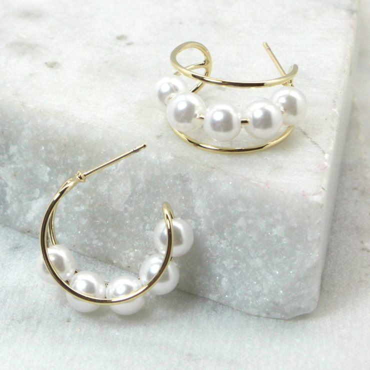 A photo of the Pearl Hooplette Earrings product