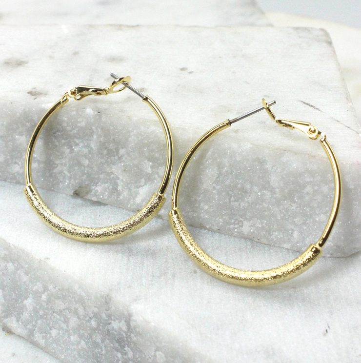 A photo of the Sand Paper Hoop Earrings product