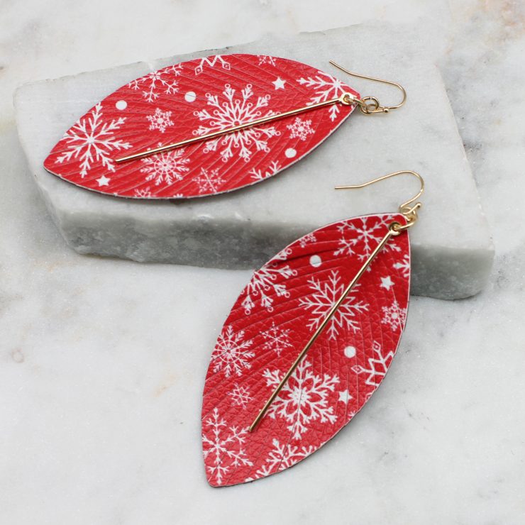 A photo of the Snowflake Feather Earrings product