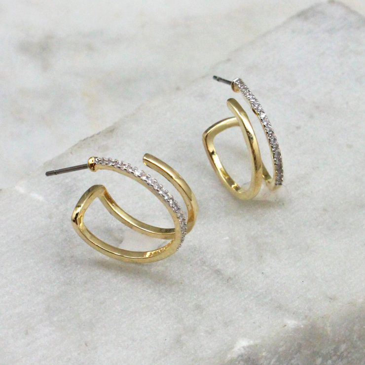 A photo of the Lucia Hoop Earrings product