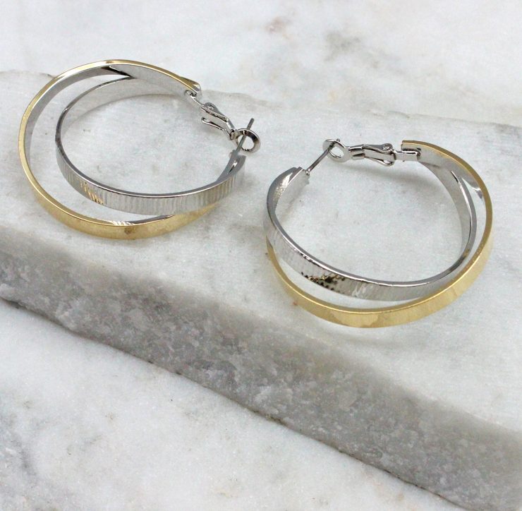 A photo of the Twisted Up Earrings In Two Tone product
