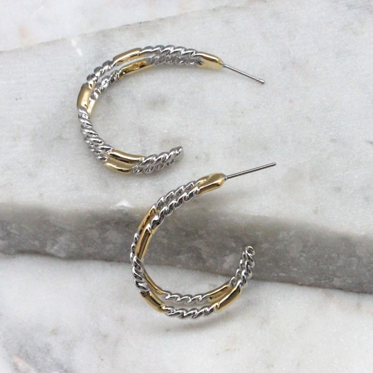 A photo of the Twist & Shine Hoop Earrings product