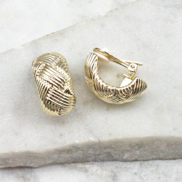 A photo of the Woven Clip On Earings In Gold product