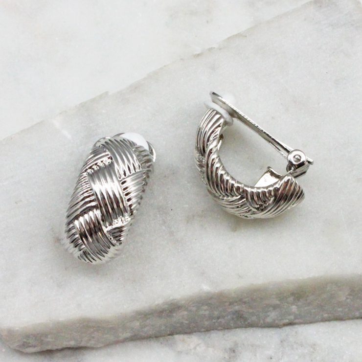 A photo of the Woven Clip On Earrings In Silver product