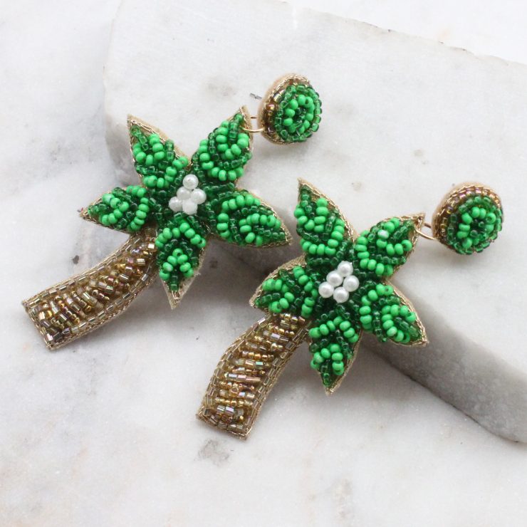 A photo of the Beaded Palm Tree Earrings product