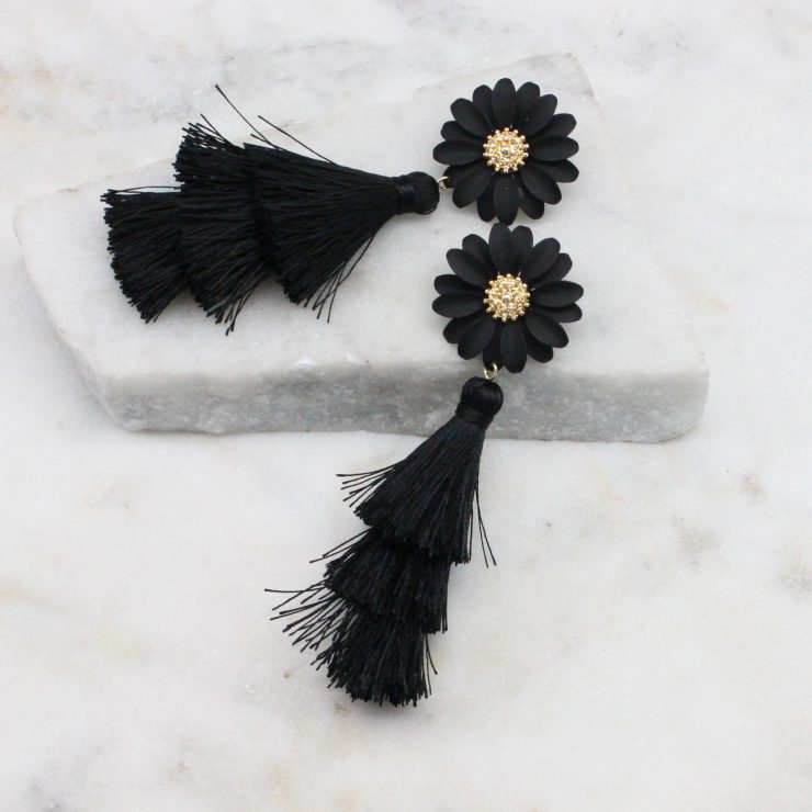 A photo of the Daisy Tassel Earrings In Black product