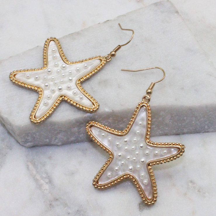 A photo of the Starfish Pearl Earrings product