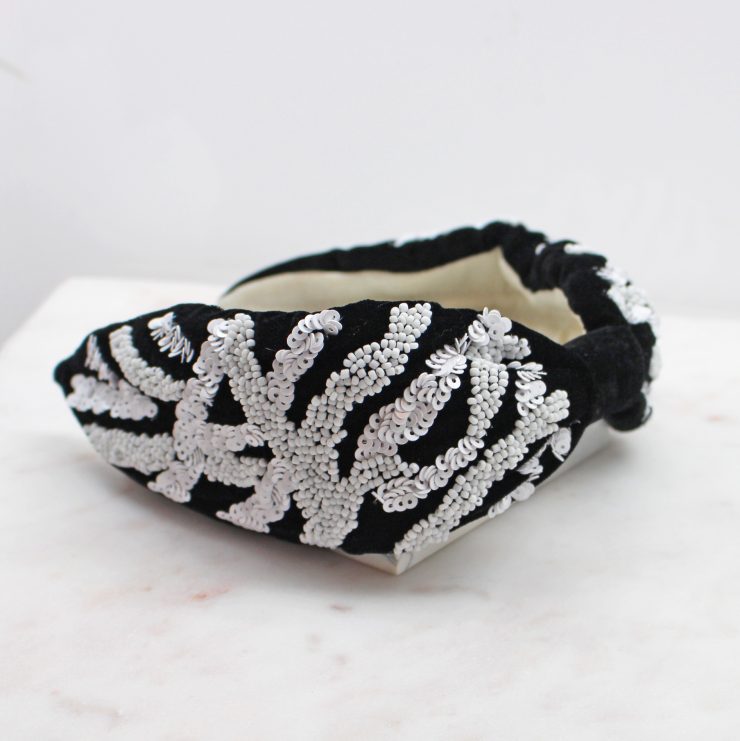 A photo of the Black & White Beaded Headband product