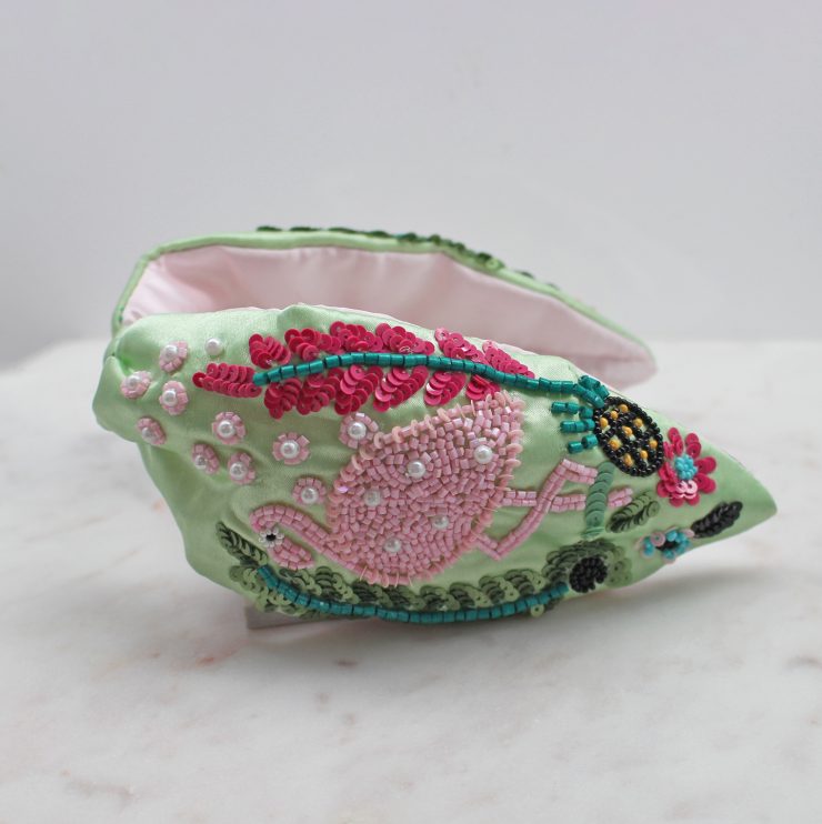 A photo of the Flamingo Beaded Headband product