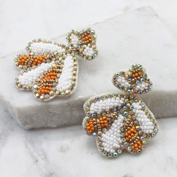 A photo of the Beaded Shell Earrings In White product