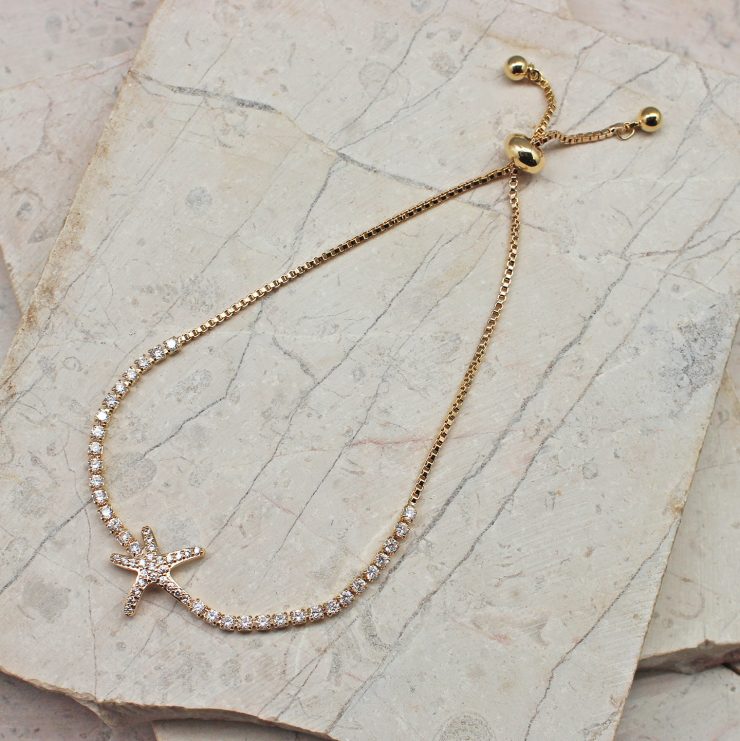 A photo of the Dazzling Starfish Adjustable Bracelet In Gold product