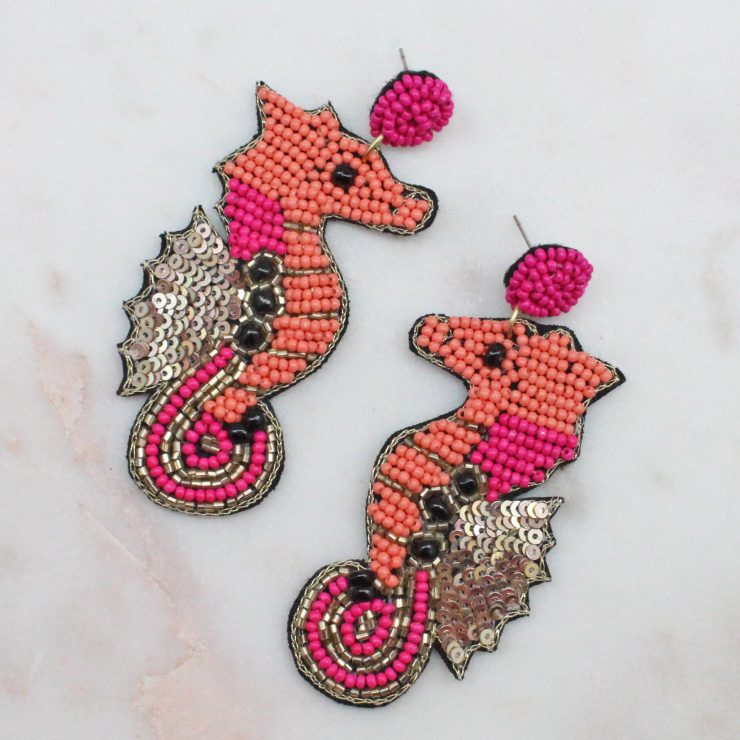 A photo of the Seahorse Earrings In Pink product