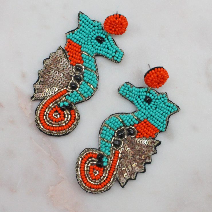 A photo of the Seahorse Earrings In Turquoise product