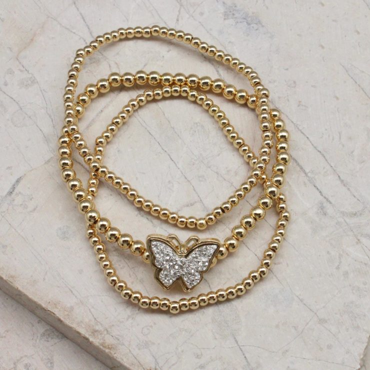 A photo of the Butterfly Beaded Stack Bracelet Set product