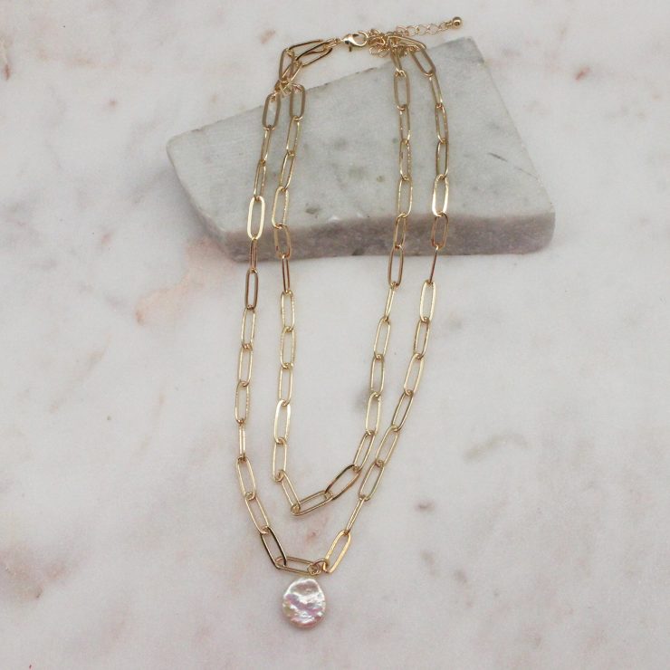 A photo of the Pretty Pearl Paper Clip Necklace In Gold product