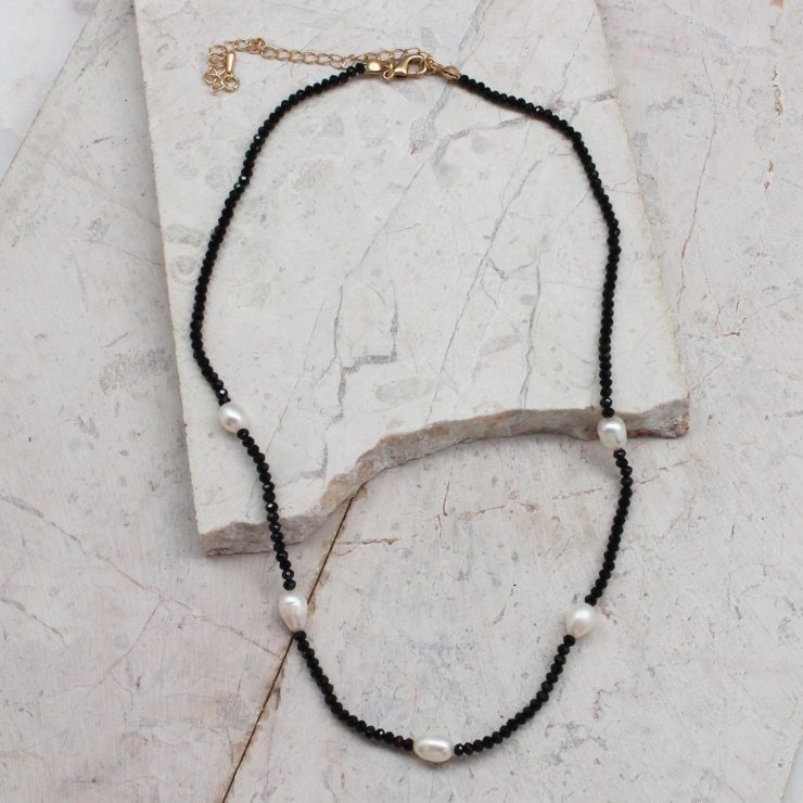 A photo of the Beaded Pearl Necklace In Black product