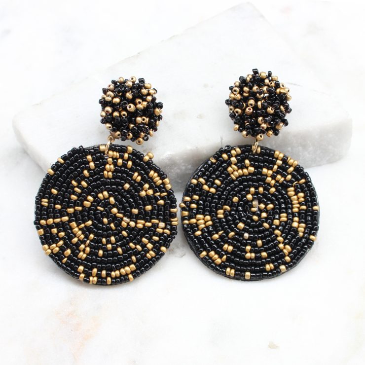 A photo of the Lizzy Earrings In Black & Gold product