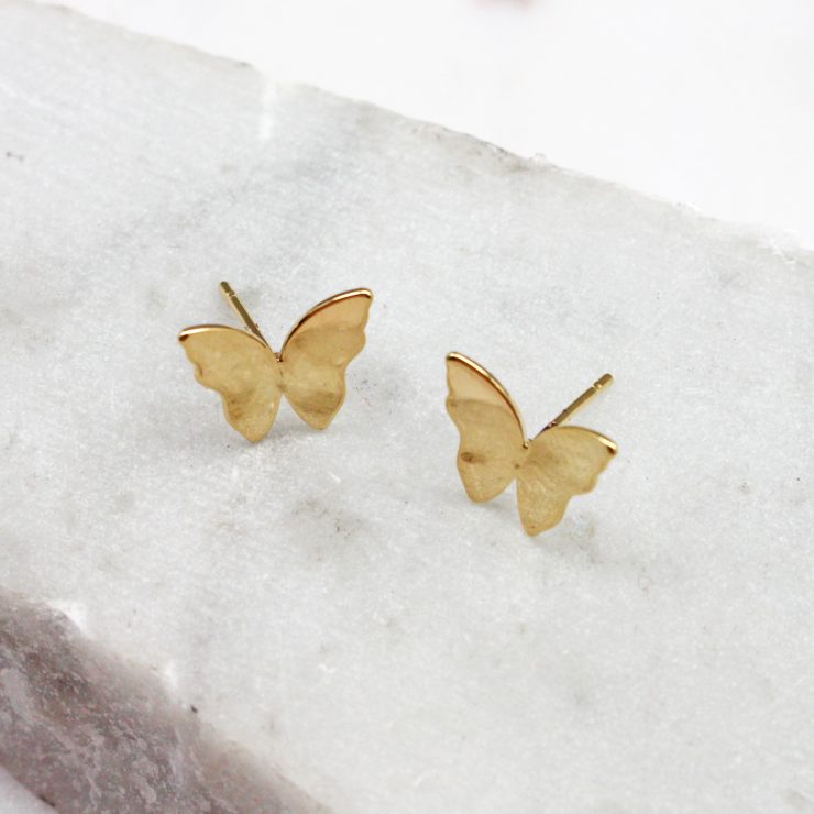 A photo of the Butterfly Stud Earrings In Gold product