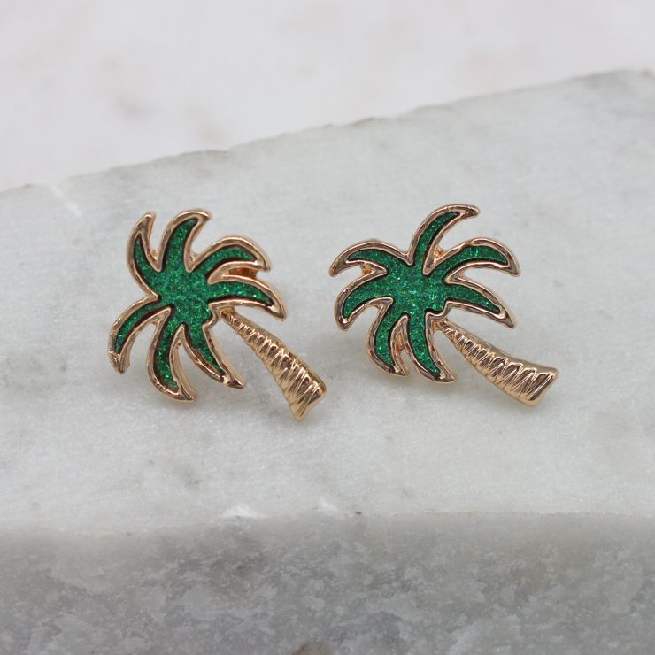 A photo of the Crescent Palm Earrings In Green product