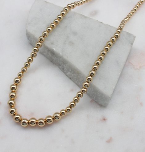 A photo of the Graduated Gold Beaded Necklace product