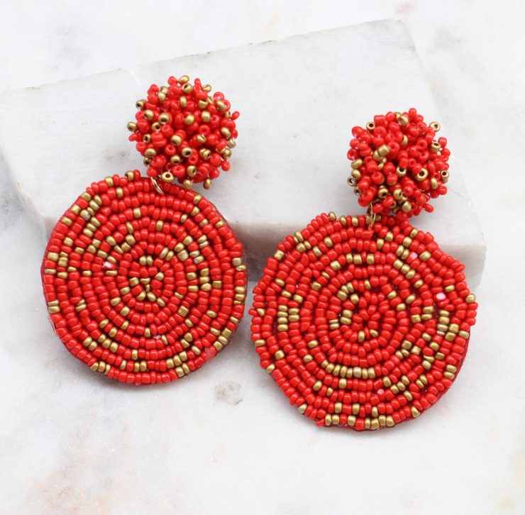 A photo of the Lizzy Earrings In Red & Gold product